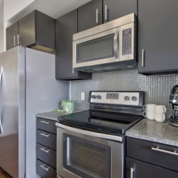 Premium appliances, modern finishes, endless possibilities Modern kitchen with island, espresso cabinetry, stainless steel appliances and granite countertops