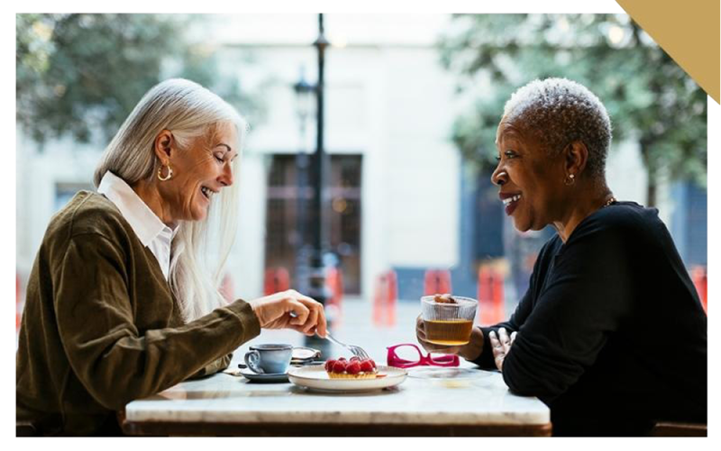 two people sitting at a table with food
