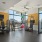 Bright fitness center with premium equipment and accessories and corner windows with city views