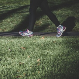 Walking in the community is an easy and free way to stay active a person walking by green grass